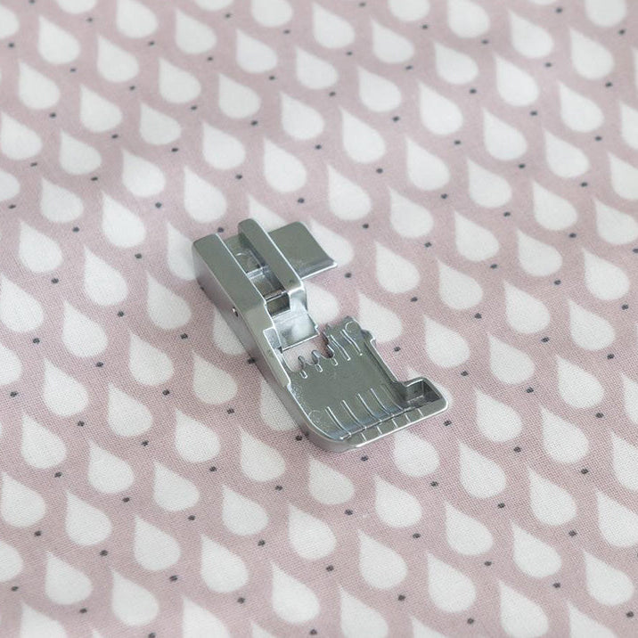 Teflon foot on a pink fabric with white teardrop pattern